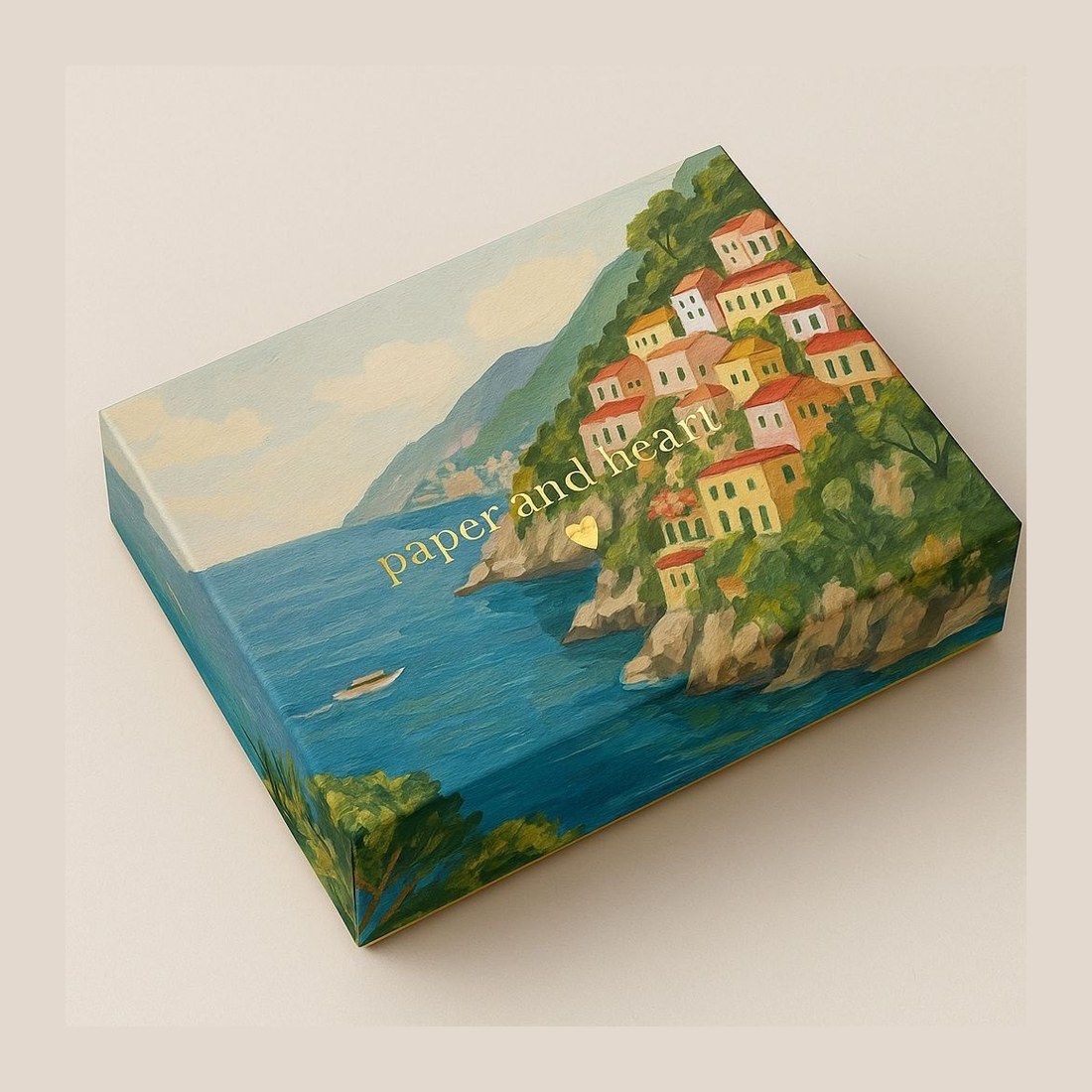 A box hand-painted with a cliffside coastal town